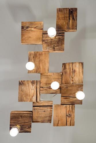 a wooden wall art with lights on a wall at Pensiunea Salina Gymnasium in Turda