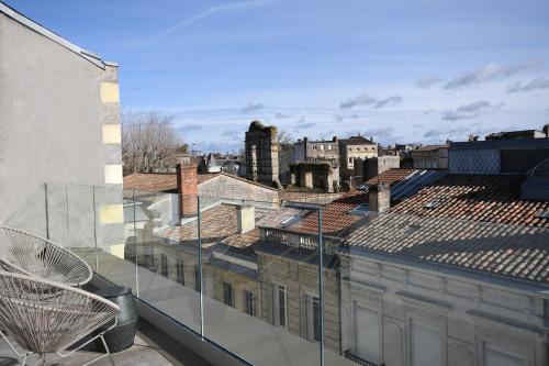 a view of a city from the balcony of a building at Hôtel La Maison Bord'eaux in Bordeaux