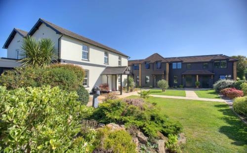 a house with a yard with bushes at Denbies Vineyard Hotel in Dorking