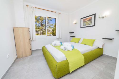 a bedroom with a large bed and a window at Apartamento Vista Brava in Playa de Muro