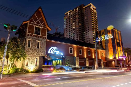 a building with neon signs on the side of a street at Venice Motel in Taichung