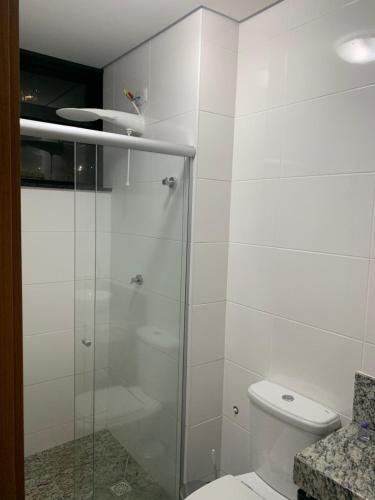 a bathroom with a glass shower with a toilet at Locking's Lourdes 1 in Belo Horizonte