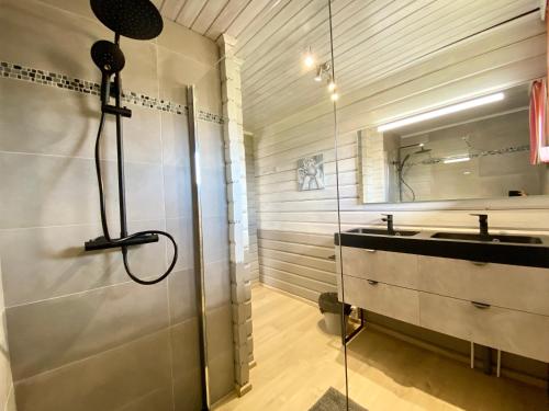 a bathroom with a shower and a sink at Chalet de Charme in Rochehaut