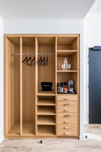 a closet with wooden shelves and a drawer at Le Grand Quartier in Paris