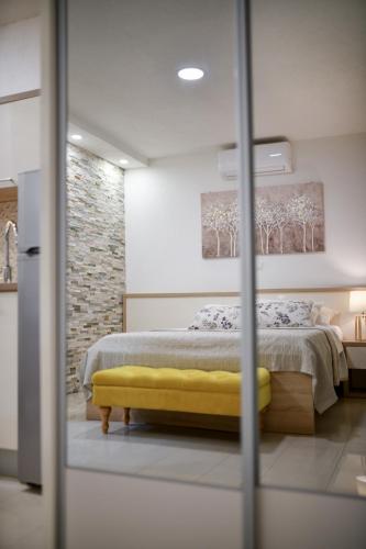 a bedroom with a bed and a yellow bench at Apartments Diora in Seline