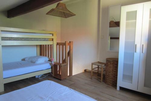 a bedroom with a bunk bed and a ladder to a bunk bed at Appartement Pour 3/4 Personnes Avec Vue Sur Le Port De Plaisance- Residence Notre-Dame in Capbreton