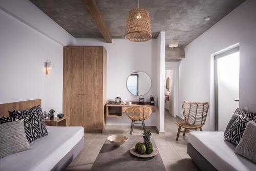 a living room with a couch and a table at Enorme Maya Beach Hotel-Adults Only in Gouves