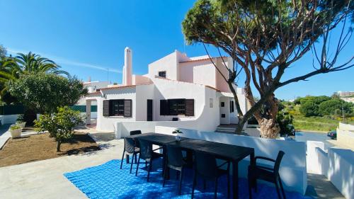 une table et des chaises noires devant une maison dans l'établissement Azinheira by Check-in Portugal, à Albufeira