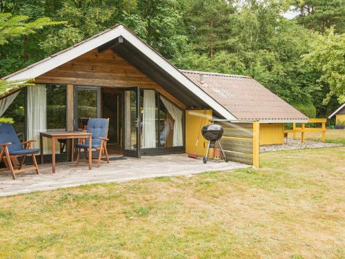 a small cabin with a grill in the yard at 6 person holiday home in Toftlund in Arrild