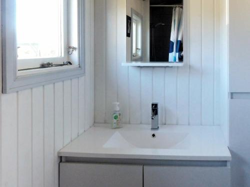 a bathroom with a white sink and a mirror at Five-Bedroom Holiday home in Fjerritslev in Torup Strand
