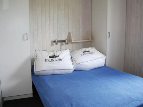 a bedroom with two white pillows on a bed at Five-Bedroom Holiday home in Fjerritslev in Torup Strand