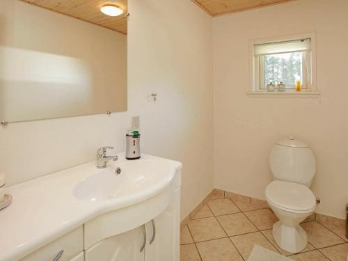 a bathroom with a white sink and a toilet at 8 person holiday home in Spøttrup in Spottrup