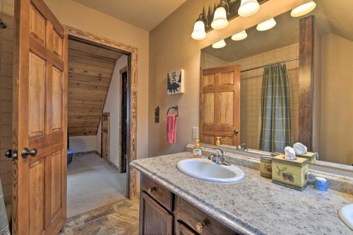 a bathroom with a sink and a mirror at Updated Mtn Home with Deck on Uncompahgre River in Ouray