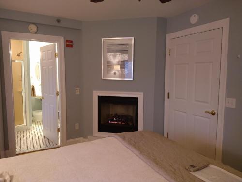a bedroom with a bed and a fireplace at Tandem Bike Inn in Belmar