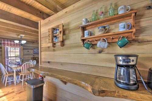 a log cabin with a coffee maker on a counter at The Lake Place Cabin with Golf Cart and Free Kayaks! in Lavonia