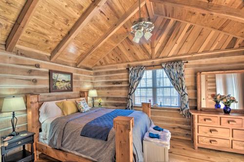 een slaapkamer met een bed en een houten plafond bij The Lake Place Cabin with Golf Cart and Free Kayaks! in Lavonia