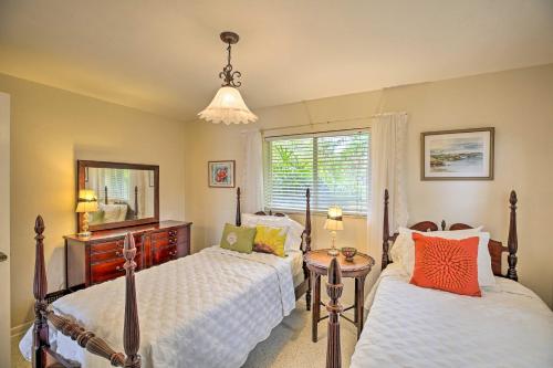 a bedroom with two beds and a mirror at Cape Coral Home with Yard Less Than 1 Mi to Dtwn! in Cape Coral