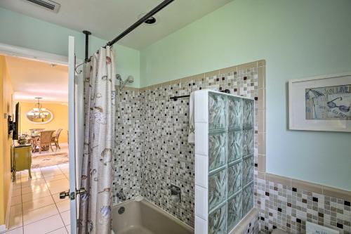 a bathroom with a tub and a shower curtain at Cape Coral Home with Yard Less Than 1 Mi to Dtwn! in Cape Coral