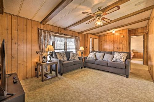 a living room with a couch and a ceiling fan at Richfield Home with Views about 13 Miles to Natl Park in Richfield