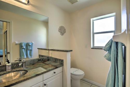a bathroom with a sink and a toilet and a mirror at Indian Rocks Beach Oasis - 2 Blocks to Beach! in Clearwater Beach