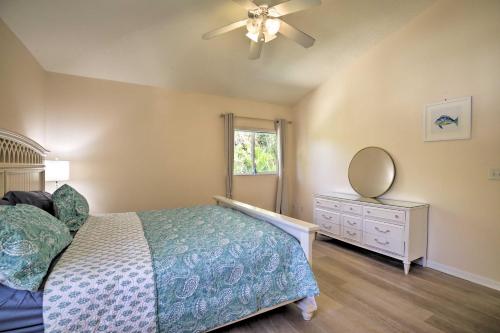 a bedroom with a bed and a mirror and a dresser at Indian Rocks Beach Oasis - 2 Blocks to Beach! in Clearwater Beach