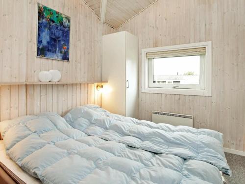 a large bed in a room with a window at Three-Bedroom Holiday home in Hejls 7 in Hejls
