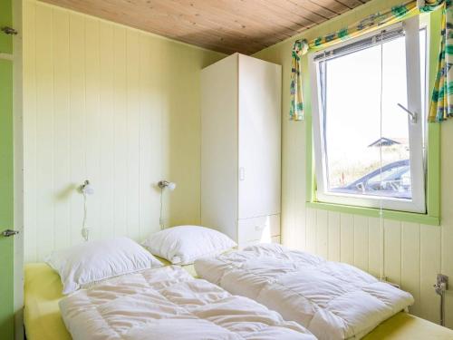 a room with two beds in it with a window at 6 person holiday home in Henne in Henne Strand