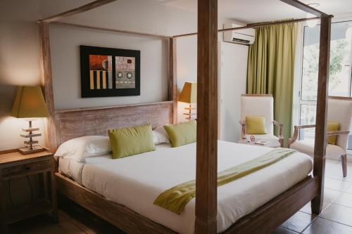 A bed or beds in a room at La Pagerie - Tropical Garden Hotel