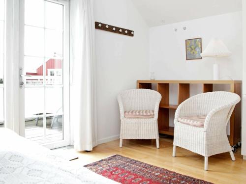 a bedroom with two chairs next to a desk at 4 person holiday home in Blåvand-By Traum in Blåvand