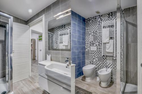 a bathroom with a sink and a toilet at Tourist Apartment Civitavecchia in Civitavecchia