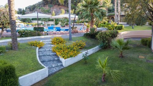 a resort with a garden with flowers and plants at Hotel Aktea in Lipari