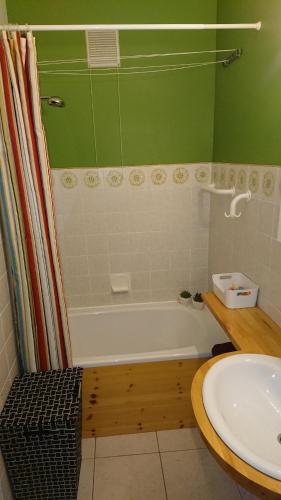 a bathroom with a bath tub and a sink at Studio Algarve in Middelkerke