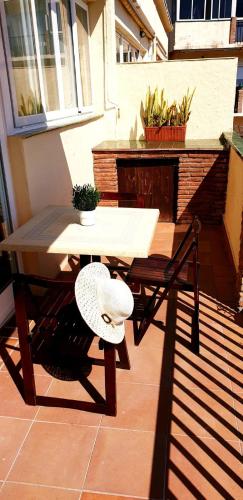 a table and a hat sitting on a patio at Apartamento Blancomar in Torremolinos