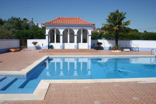 a swimming pool in front of a house at Sol Poente in Évora