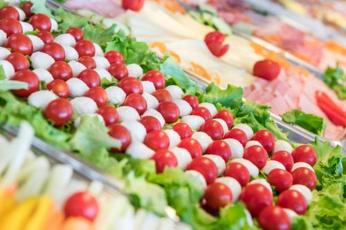 a display of salad foods with cherries and lettuce at Hotel Katja in Bibione