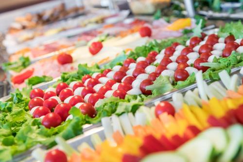 a buffet of food with fruits and vegetables on display at Hotel Katja in Bibione