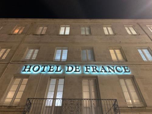 a hotel de france sign on the side of a building at Hotel de France Citotel in Rochefort
