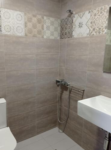 a bathroom with a shower and a sink at PANORAMA in Pitsidia