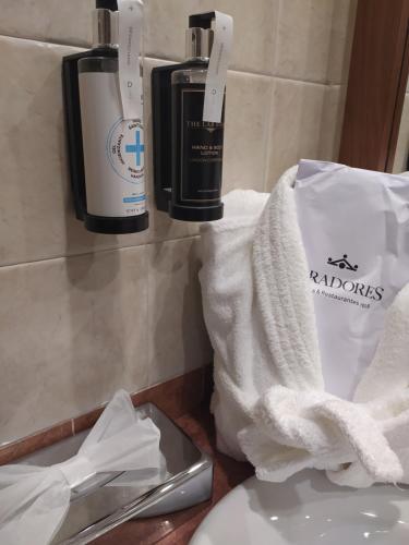 a bathroom with two bottles of soap and a towel at Parador de Limpias in Limpias
