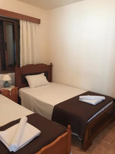a bedroom with two beds with towels on them at Pomos Small Sunny House in Pomos