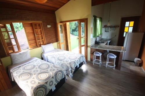 Una cama o camas en una habitación de Pousada Campestre Sítio da Lua