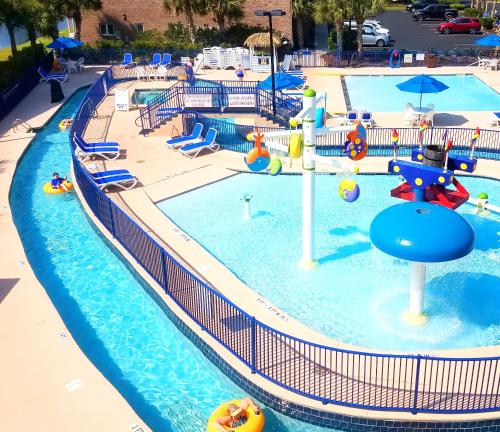 a swimming pool with a water park with a water slide at Grand Palms Resort in Myrtle Beach