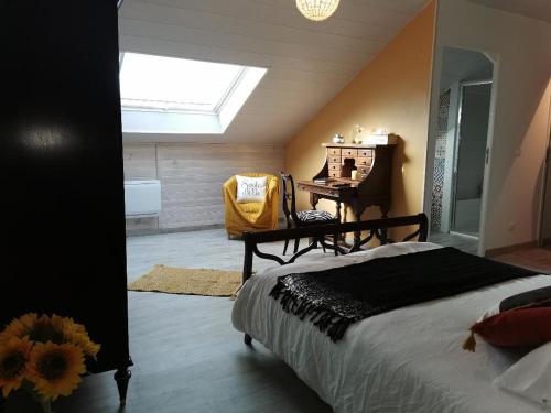 a bedroom with a bed and a desk and a window at ETCHE ARGUINIA CHAMBRES HOTES et SPA in Montory