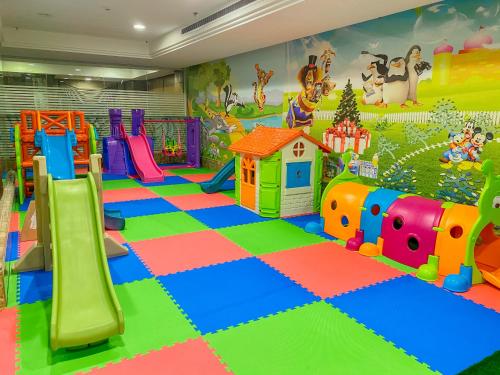 a childrens play room with a slide and a playground at Afraa Hotel Al Aziziya in Mecca