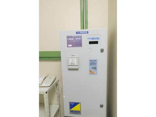 a white vending machine in a room with a phone at R&B HOTEL NAGOYA SAKAE HIGASHI - Vacation STAY 14030v in Nagoya