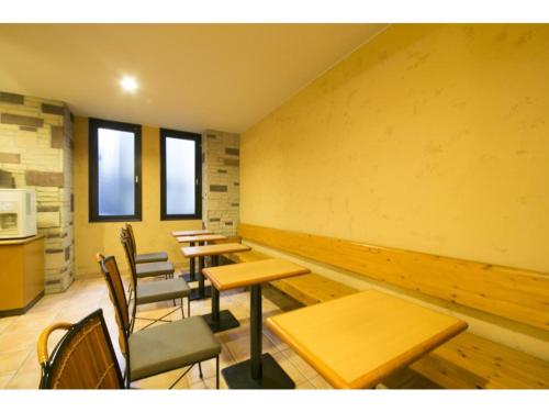 a row of tables and chairs in a room at R&B HOTEL NAGOYA SAKAE HIGASHI - Vacation STAY 14023v in Nagoya