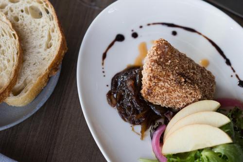 a plate of food with a sandwich and apples at Origin Westminster a Wyndham Hotel in Westminster
