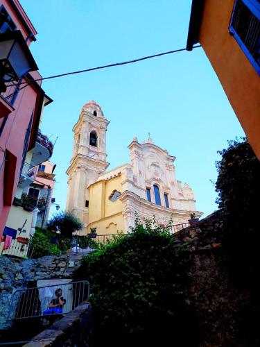 a large building with a clock tower in a city at tra il borgo e il mare in Cervo