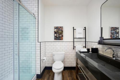 a bathroom with a toilet and a sink at Origin Westminster a Wyndham Hotel in Westminster