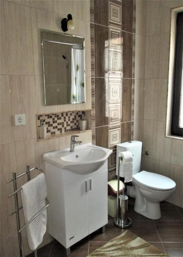 a bathroom with a white sink and a toilet at Studio Emi in Pomorie